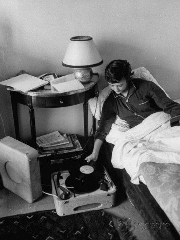 french-authoress-francoise-sagan-laying-in-bed-listening-to-music